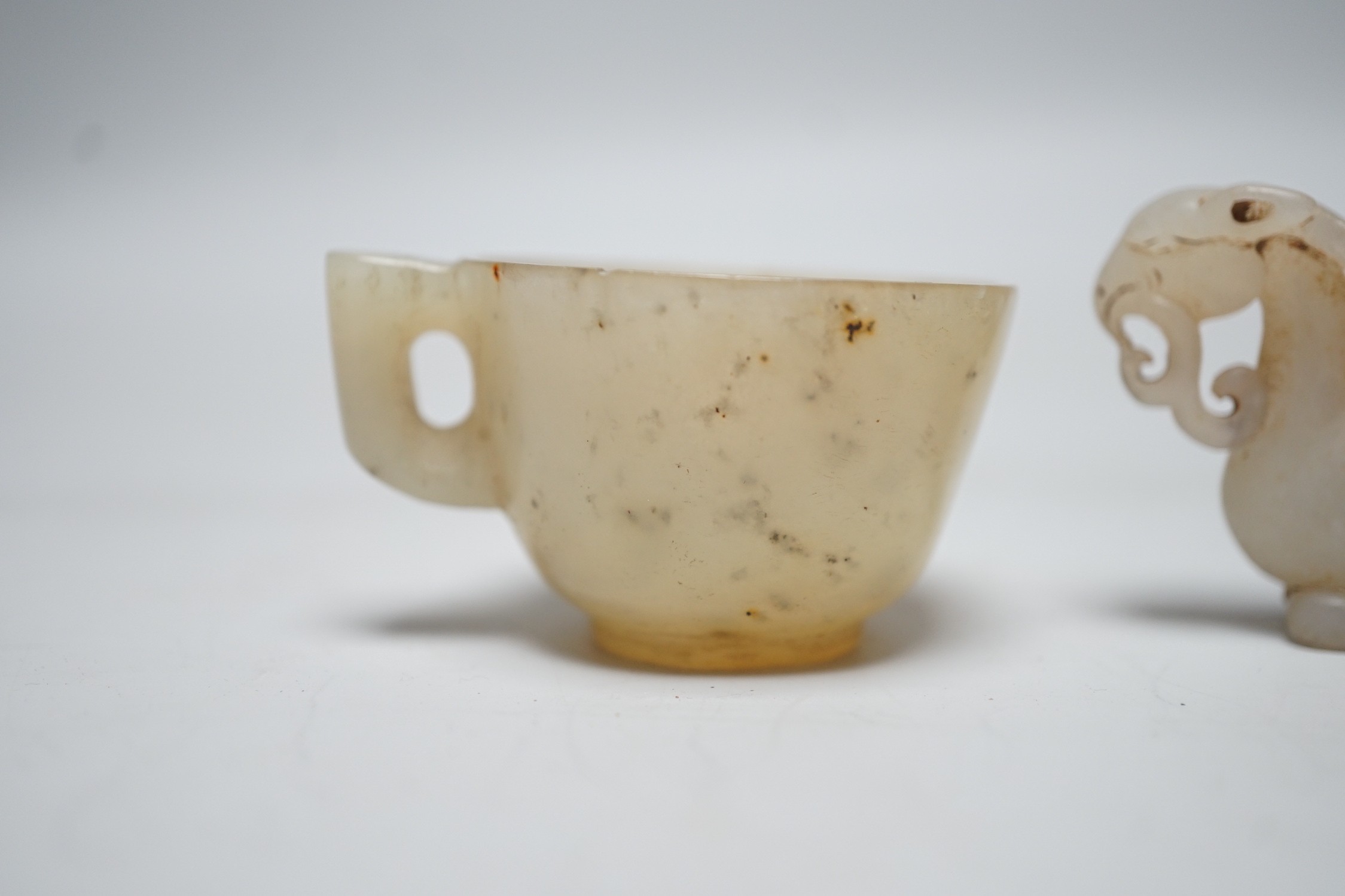 A Chinese hardstone rhyton cup and a bowenite jade cup, largest 9cm